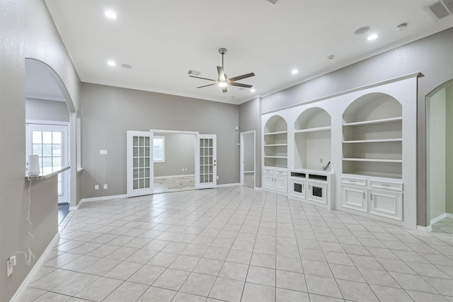 unfurnished living room featuring built in features, a ceiling fan, visible vents, light tile patterned floors, and baseboards