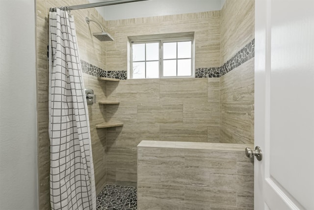 full bathroom with tiled shower