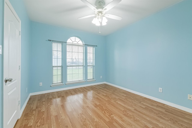 spare room with ceiling fan, baseboards, and light wood-style flooring