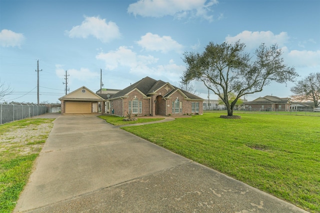 view of front of house with a front yard, fence, concrete driveway, a garage, and brick siding