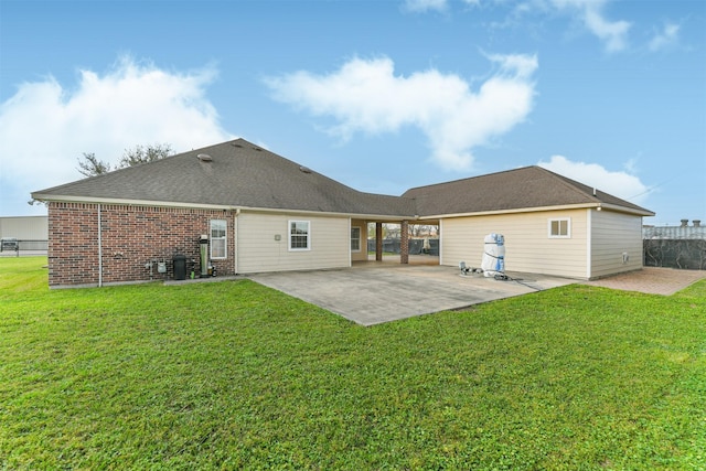 rear view of house featuring a patio, fence, a lawn, and brick siding