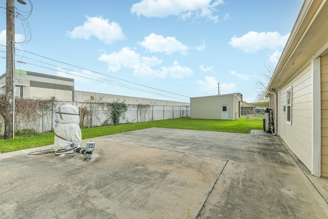 view of patio with an outdoor structure and a fenced backyard