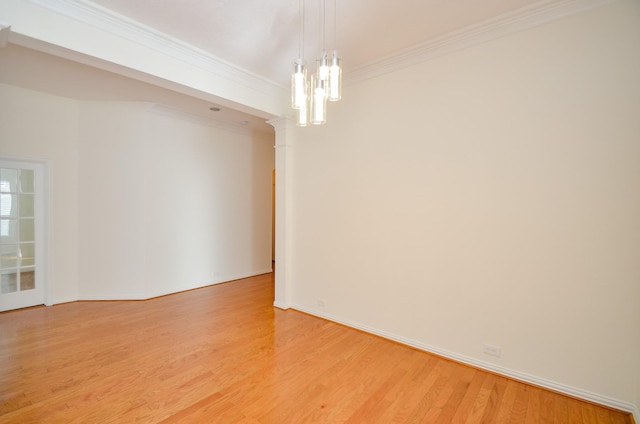 unfurnished room featuring baseboards, crown molding, and light wood finished floors