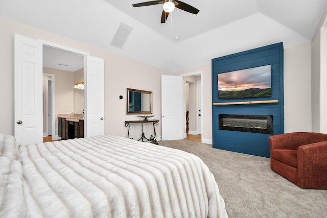 carpeted bedroom featuring visible vents, ceiling fan, a large fireplace, and lofted ceiling