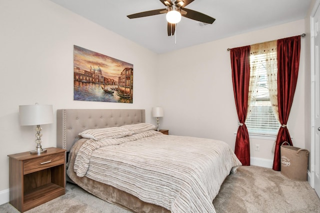 carpeted bedroom featuring ceiling fan and baseboards