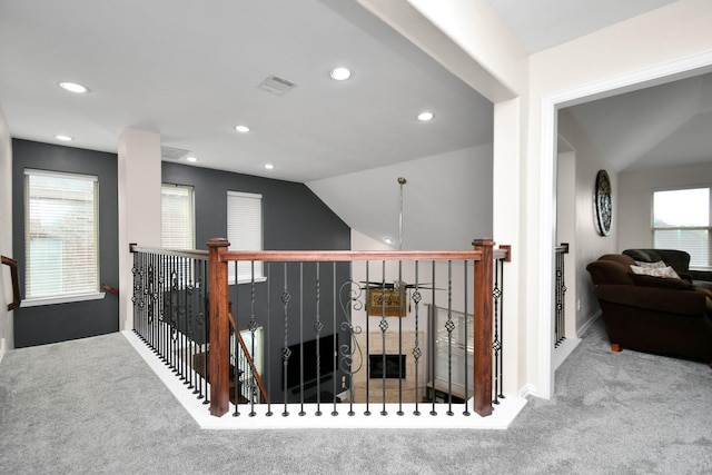 hall with recessed lighting, visible vents, carpet flooring, and vaulted ceiling