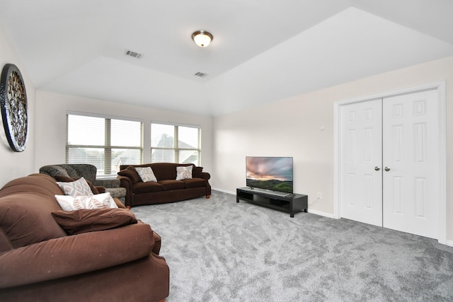 carpeted living room featuring vaulted ceiling, baseboards, and visible vents