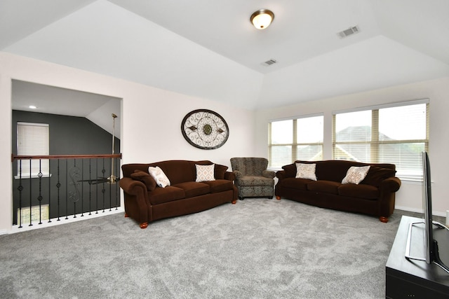 living room with visible vents, carpet floors, baseboards, and vaulted ceiling