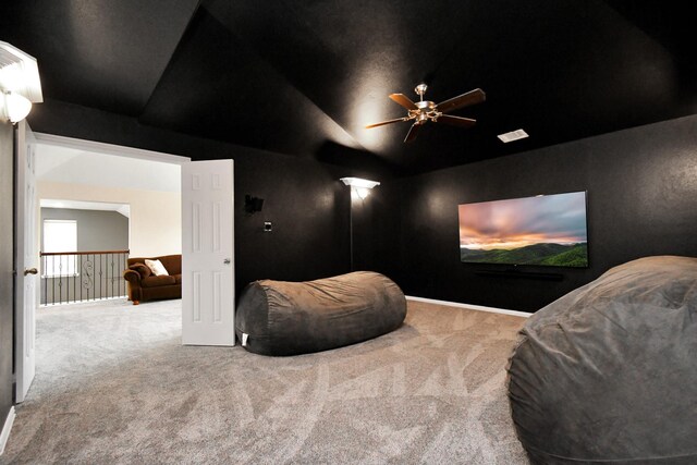 cinema featuring carpet, a ceiling fan, and vaulted ceiling