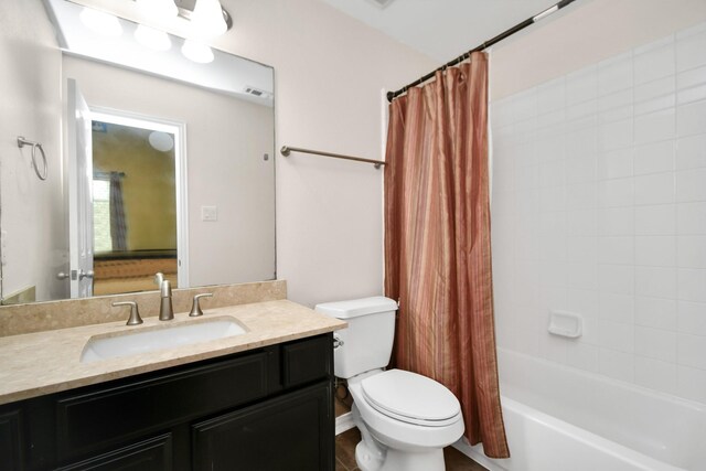 full bathroom featuring vanity, toilet, visible vents, and shower / bath combo