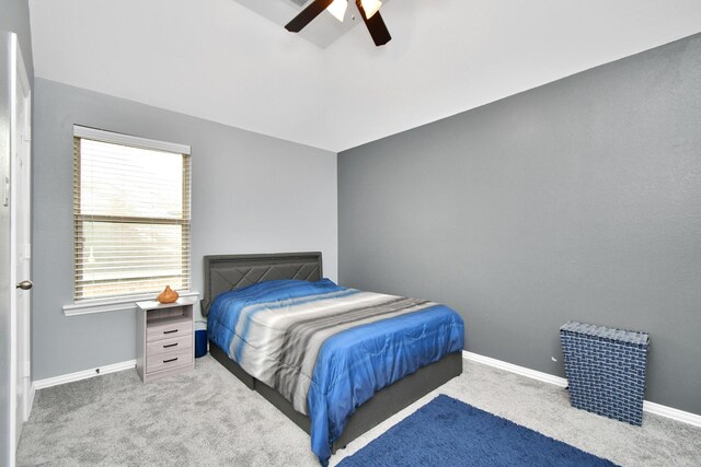 carpeted bedroom with baseboards, lofted ceiling, and a ceiling fan