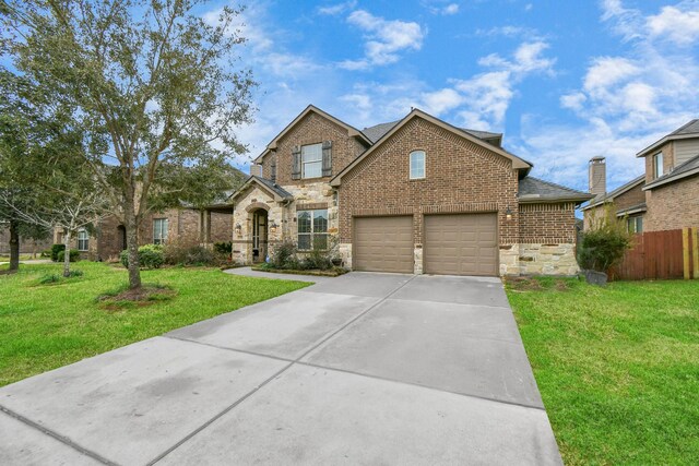 traditional home with brick siding, a shingled roof, a front lawn, fence, and driveway