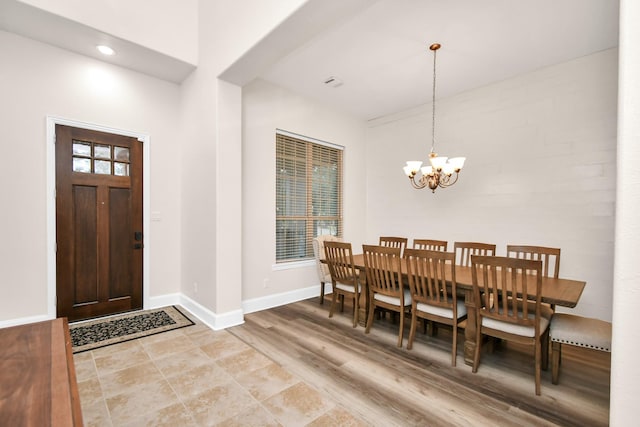 entryway with recessed lighting, baseboards, light wood finished floors, and a chandelier