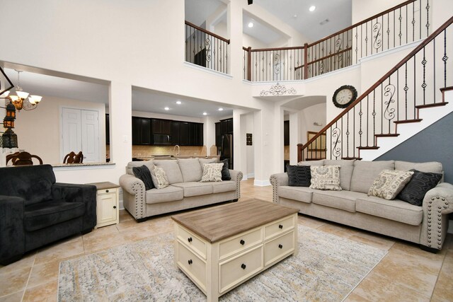 living area featuring recessed lighting, stairway, baseboards, and an inviting chandelier