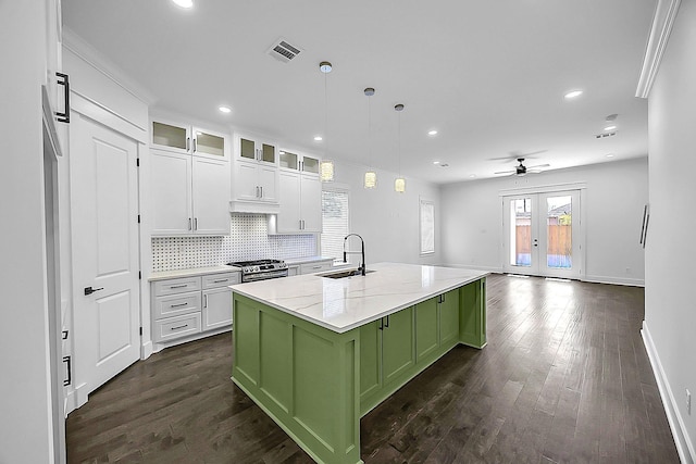6716 Ave R, Houston, TX 77011 - kitchen with green cabinets, a sink, white cabinets, dark wood finished floors, and recessed lighting