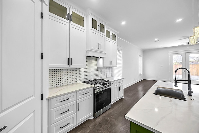 6716 Ave R, Houston, TX 77011 - kitchen with stainless steel range, a sink, dark wood finished floors, decorative backsplash, and light stone countertops