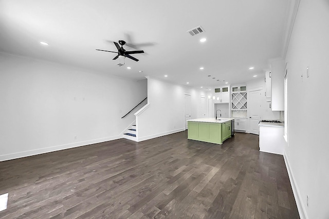 6716 Ave R, Houston, TX 77011 - unfurnished living room with recessed lighting, stairway, a sink, dark wood finished floors, and baseboards