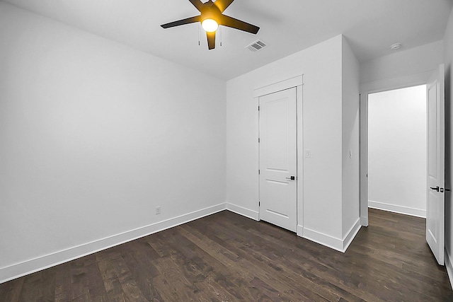 6716 Ave R, Houston, TX 77011 - unfurnished bedroom with dark wood-type flooring, baseboards, and a ceiling fan