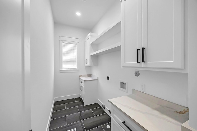 6716 Ave R, Houston, TX 77011 - laundry room with cabinet space, hookup for an electric dryer, baseboards, dark tile patterned flooring, and recessed lighting