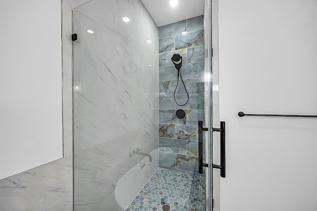 6716 Ave R, Houston, TX 77011 - bathroom featuring tiled shower and tile patterned floors