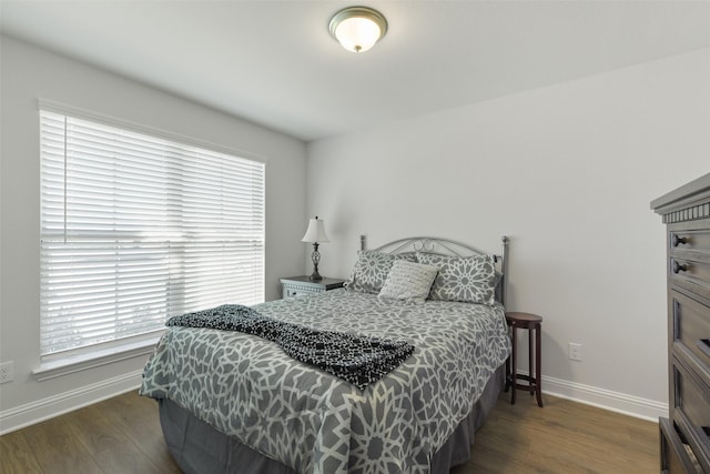 bedroom featuring baseboards and wood finished floors