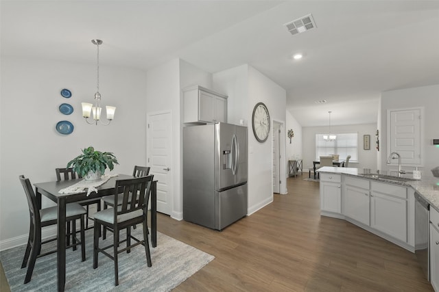 dining area featuring wood finished floors, baseboards, visible vents, recessed lighting, and a chandelier