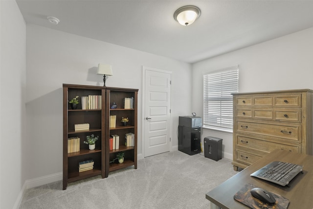 office area with baseboards and light carpet