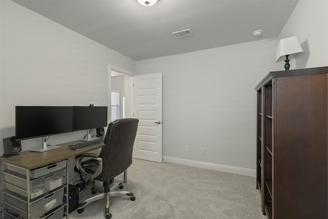 office area featuring light carpet, visible vents, and baseboards