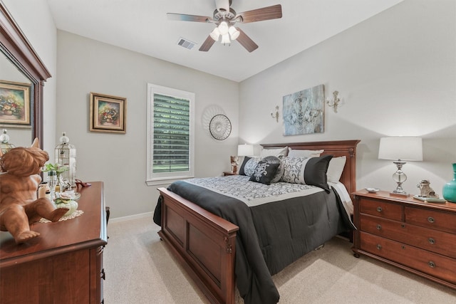 bedroom featuring visible vents, light colored carpet, a ceiling fan, and baseboards