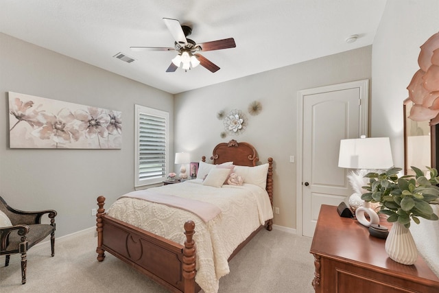 bedroom with visible vents, light carpet, baseboards, and a ceiling fan