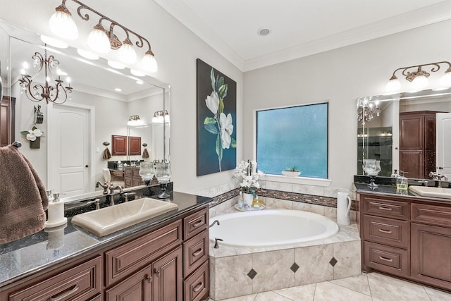 full bath with ornamental molding, two vanities, a garden tub, and a sink