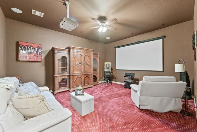 carpeted home theater featuring visible vents, a textured ceiling, baseboards, and ceiling fan