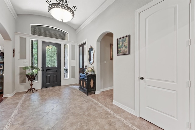 entryway featuring vaulted ceiling, baseboards, and arched walkways