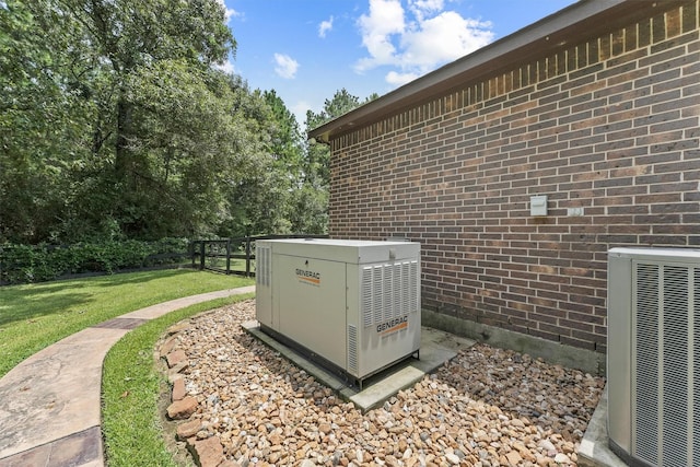 details with central air condition unit, brick siding, and a power unit