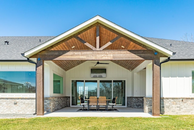 rear view of house with a patio, board and batten siding, roof with shingles, and ceiling fan