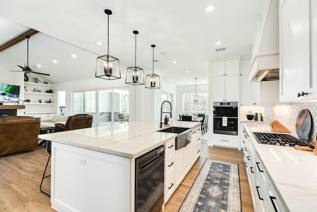 kitchen with a large island, a sink, double oven, light wood finished floors, and dishwasher