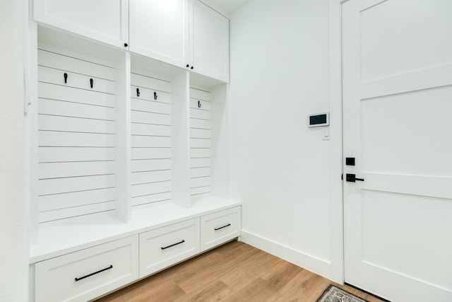 mudroom featuring light wood-style flooring and baseboards