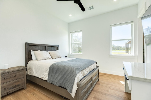 bedroom featuring recessed lighting, visible vents, light wood-type flooring, and baseboards