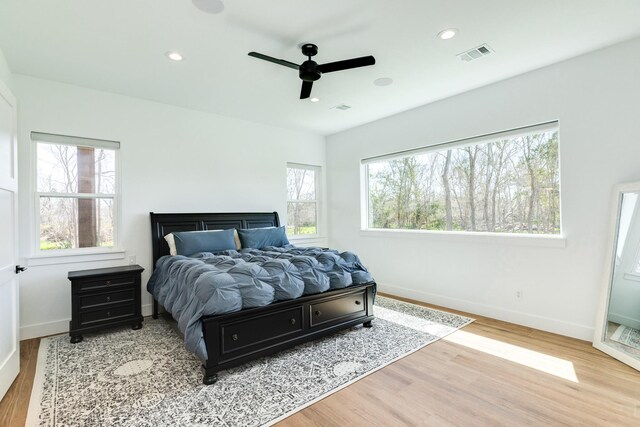 bedroom with visible vents, recessed lighting, baseboards, and wood finished floors