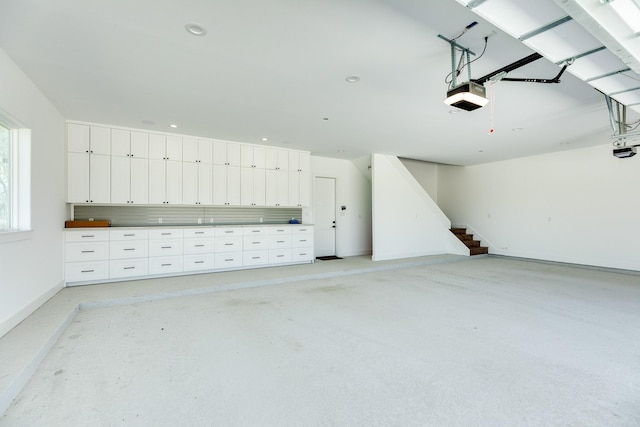 garage featuring recessed lighting and a garage door opener