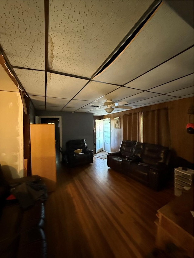 living room featuring a drop ceiling and wood finished floors