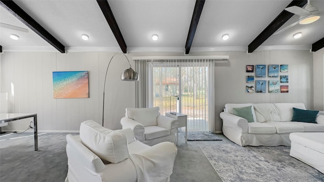 living room with beamed ceiling and concrete floors