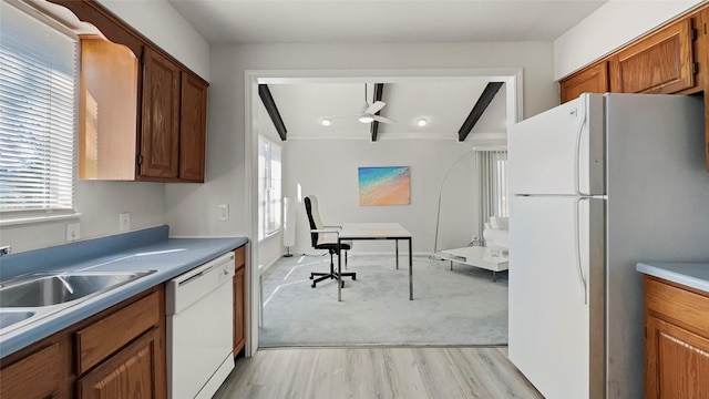 kitchen featuring a ceiling fan, white appliances, brown cabinetry, and a healthy amount of sunlight