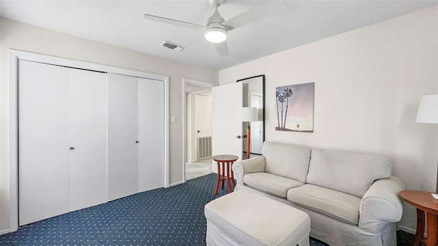 living room featuring carpet, visible vents, and ceiling fan