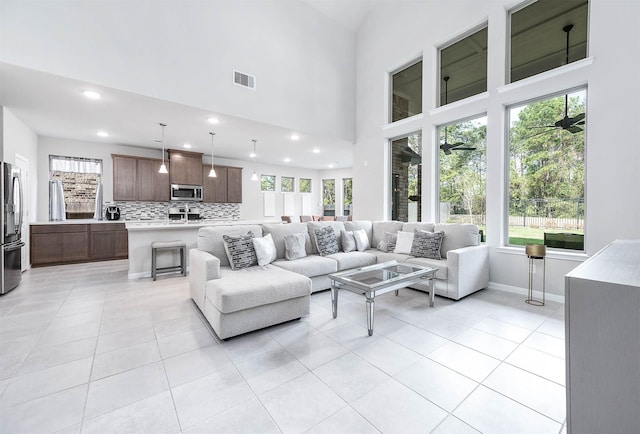 living area featuring recessed lighting, light tile patterned flooring, baseboards, and visible vents