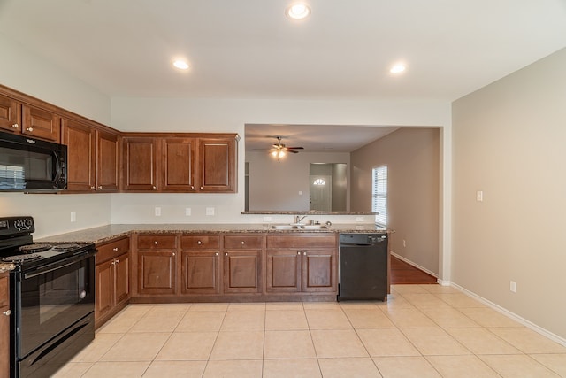 kitchen with light tile patterned floors, a ceiling fan, stone countertops, a sink, and black appliances