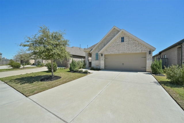 view of front of home featuring a garage, brick siding, concrete driveway, and a front yard