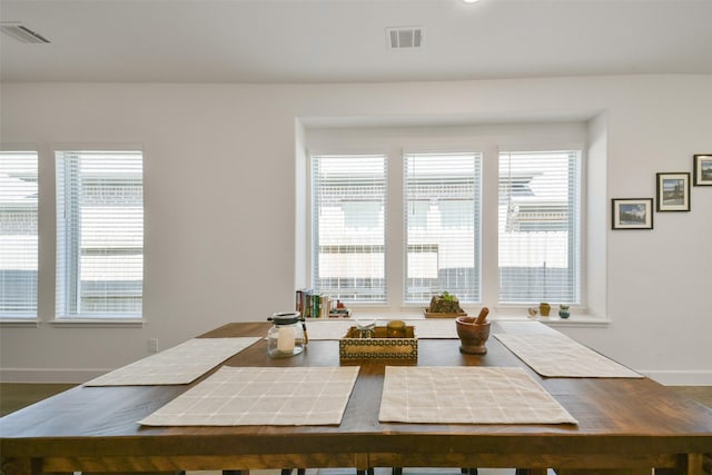 dining space with a wealth of natural light, visible vents, and baseboards