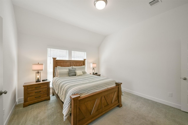 bedroom featuring lofted ceiling, light colored carpet, visible vents, and baseboards