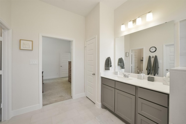 full bathroom with vanity and baseboards